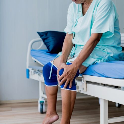 old asian senior man complains about all the aches and pains he has at his age meet doctor in hospital